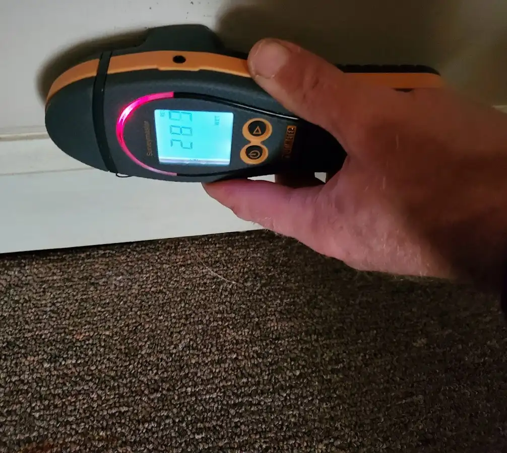 Moisture detection at baseboard during Storm Damage Restoration in Madison